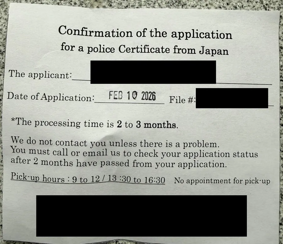 The consulate’s confirmation slip for a police certificate application from Japan, dated 10 February 2026. It says the processing time is 2 to 3 months and that applicants must call or email to check their status after 2 months. The applicant name, file number and the consulate’s address are covered with black boxes.
